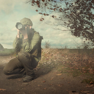 Wartime Photographer In A Field Taking Pictures
