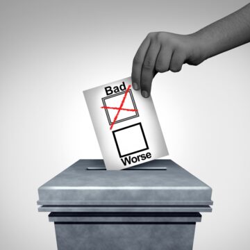 Hand Dropping Ballot In The Ballot Box With The Choice Between Bad Or Worse Candidate
