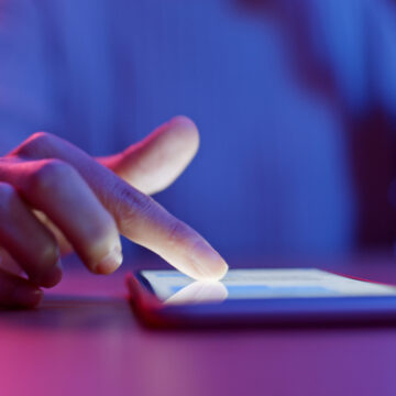 Image Of Person's Hand Using Mobile Phone