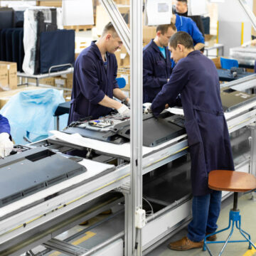 Minsk,,Belarus,-,May,08,,2018:,Workshop,For,Assembring,Televisions Factory Workers Assembling Televisions On A Production Line