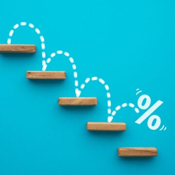 Percent Sign Moving Down Wooden Stairs On Blue Background