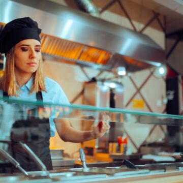 Fast,Food,Chef,Working,Behind,A,Counter,Preparing,Sandwiches.,Restaurant Fast Food Worker Behind A Counter Preparing Sandwiches