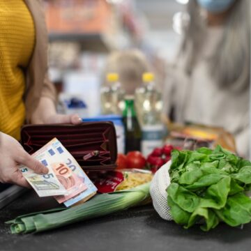 Close-up Of Woman Giving Euros At The Grocery Check-out