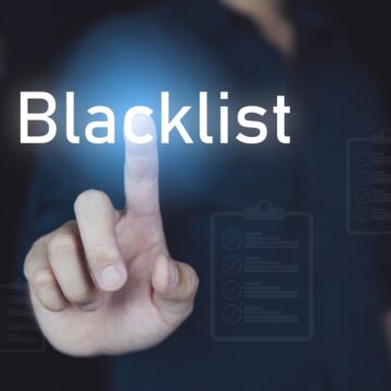Blacklist Concept With Hand On Touchscreen Touching The Word Blacklist