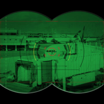 NIght Vision View Of The Exterior Of An Airport Terminal Tarmac