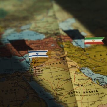 The Flags Of Israel And Iran On A Closeup Of A Map Of The Middle East