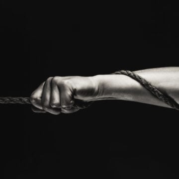 Image Of A Strong Man's Hand Holding Onto A Rope