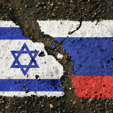 The Torn Edges Of The Flags Of Israel And Russia Against A Tarred Road