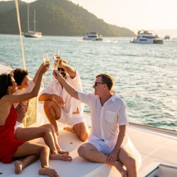 Group Of Men And Women Enjoy Themselves On A Luxury Sailboat