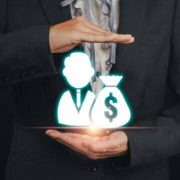 A,Businessman,In,A,Suit,Holding,A,Holographic,Icon,Representing SPOTLIGHT: BIGS GETTING BIGGER