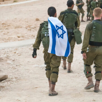 Back Shot Of Several Israeli Soldiers Walking A Carrying A Flag Of Israel