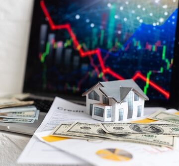 Concept Image Of Falling Real Estate Market With Downward Graph, Currency, Model Home