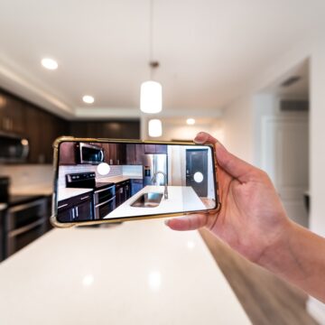Hand Photographing Newly-Built Kitchen With Mobile Phone