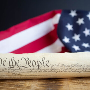 Constition,Of,The,Usa,With,Us,Flag WHEN RIGHTS BECOME PRIVILEGES: IS THE CONSTITUTION BECOMING OPTIONAL?