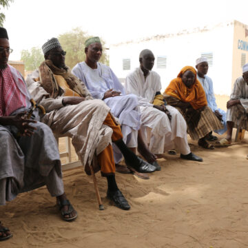 African Men And Women Sitting Together In The Rural Village In Chad Called Dourbali