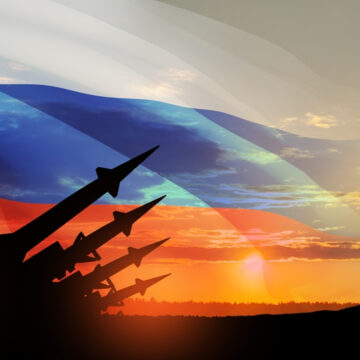 Image Of Long-Range Missiles Aimed At The Sky Against Sunset And Flag Of Russia