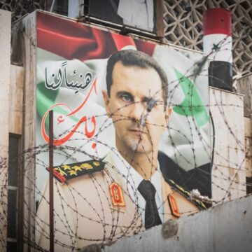 Poster Of Deposed Syrian President Bashar Al-Assad In Front Of Barbed Wire In Damascus, Syria