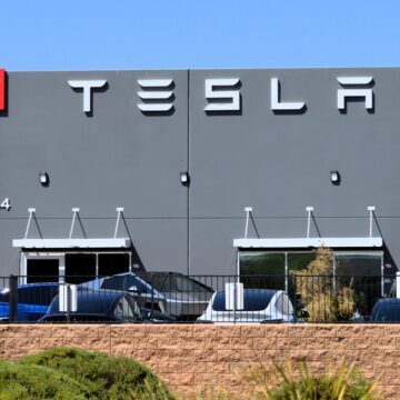 The Exterior Of A Tesla Showroom With Teslas Parked Outside In Mesa, AZ