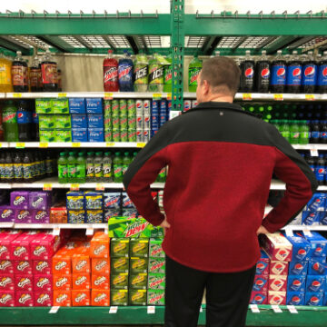 Monroe,,Louisiana,,Usa,-,December,21,,2018:,A,Caucasian,Man A Man Grocery Shopping Ponders A Full Shelf Of Sodas In Monroe, Louisiana