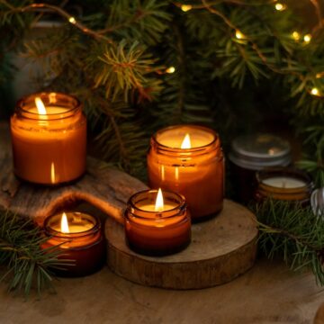 Soy,Candles,Burn,In,Glass,Jars.,Comfort,At,Home.,Candle Soy Candles Burning In Glass Jars Surrounded By Fir Tree Branches
