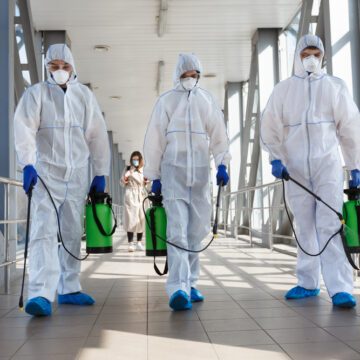 Specialists In Hazmat Suits Disinfecting Against Coronavirus