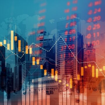 Economic Crisis Concept Shown By Declining Stock Graphs, Stock Ticker, And Corporate Buildings In Background