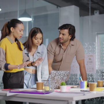 A Team Of Gen X Employees Discuss In Conference Room