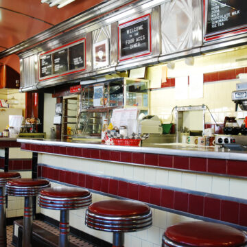 A Lone Diner Sits At A Diner Counter In West Lebanon, NH