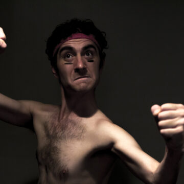 Skinny Man With Headband Shows Fighting Skills