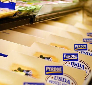 Grocery Stored Shelf Filled With Plastic-Wrapped Perdue Chicken