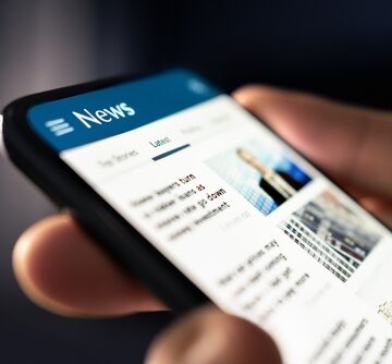 A Digital Feed Of Online News Headlines On A Mobile Phone