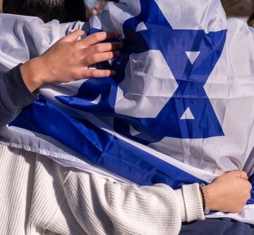 Pro-Israel Supporters Stand Together Draped In The Flag Of Israel In Washington, D.C.