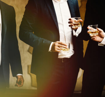 Group Of Wealthy Men With Glasses Of Whiskey