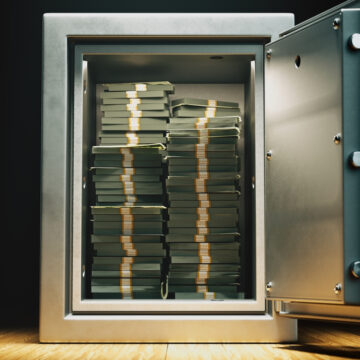 An Open Safe Filled With Stacks Of Currency
