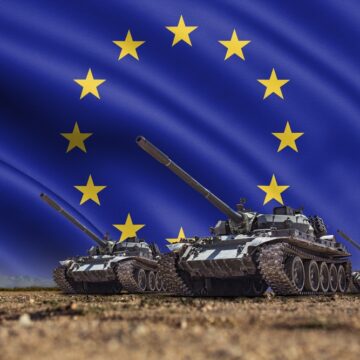 Tanks,Lined,Up,In,Front,Of,A,European,Union,Or Tanks Lined Up In Front Of A Large European Union Flag