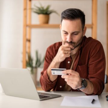 Serious,Business,Man,Sitting,At,Table,In,Home,Office,,Holding AN INFLATIONARY NIGHTMARE IS RAPIDLY APPROACHING—AND AS OF NOW, THERE IS NO WAY TO STOP IT