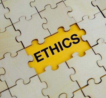 Wooden Jigsaw Puzzle With Missing Piece Thats Shows The Word "Ethics"