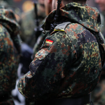 GERMANY’S CHANCELLOR-IN-WAITING AIMS TO PUMP UP MILITARY SPENDING