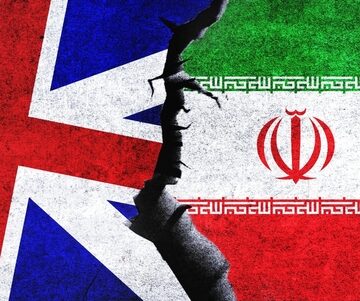 The Flags Of The United Kingdom And Iran Clashing Together