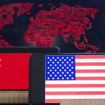 American And China Flags On A Smartphone Screen With World Map In Background