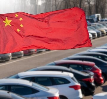 Chinese Flag With A Lot Full Of Cars In The Background
