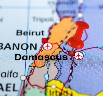 A Red Pin Stuck Into A Map Marking The Location Of Damascus