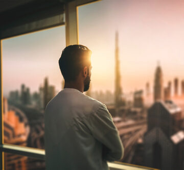 Pensive Business Man Looking Out At A City Skyline