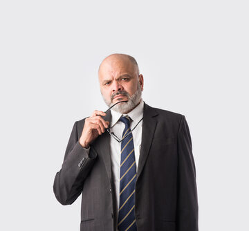 Pensive Businessman Holding His Eyeglasses