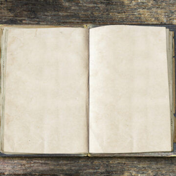 Vintage,Book,,Open,,On,Old,Wooden,Table,,With,Clipping,Path LET’S NOT FORGET