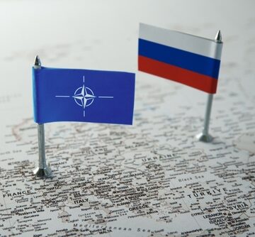NATO And Russian Flags On A European Geopolitical Map