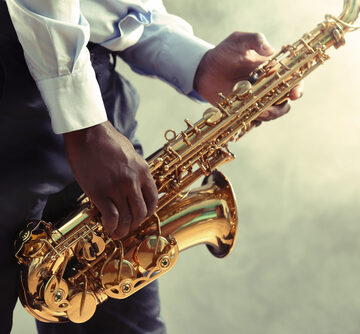 A Closeup Of A Jazz Musician Playing The Saxophone