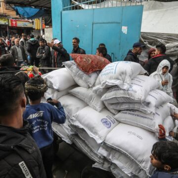 Palestinians Crowd To Receive Food Supplies At An UNRWA School