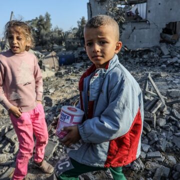 Bedraggled Palestinian Children Stand Amidst The Rubble From Israeli Airstrikes