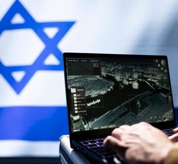 Israeli Army Specialist Using Target Acquisition Tech On Laptop In Front Of Israeli Flag